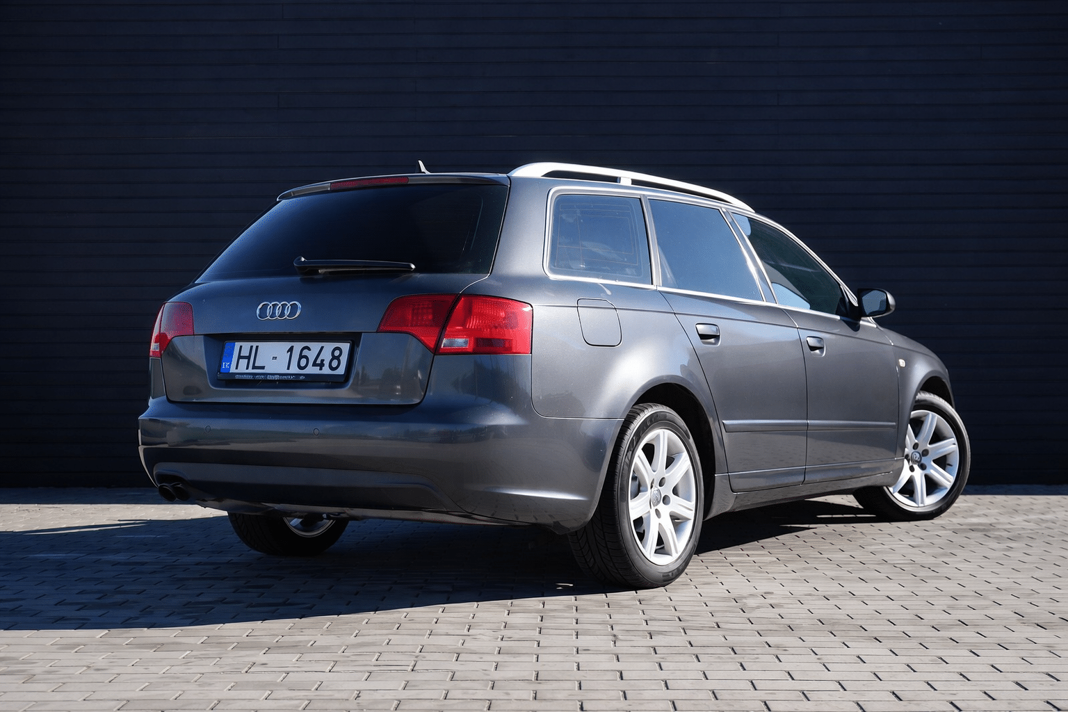 Audi station wagon by wooden wall