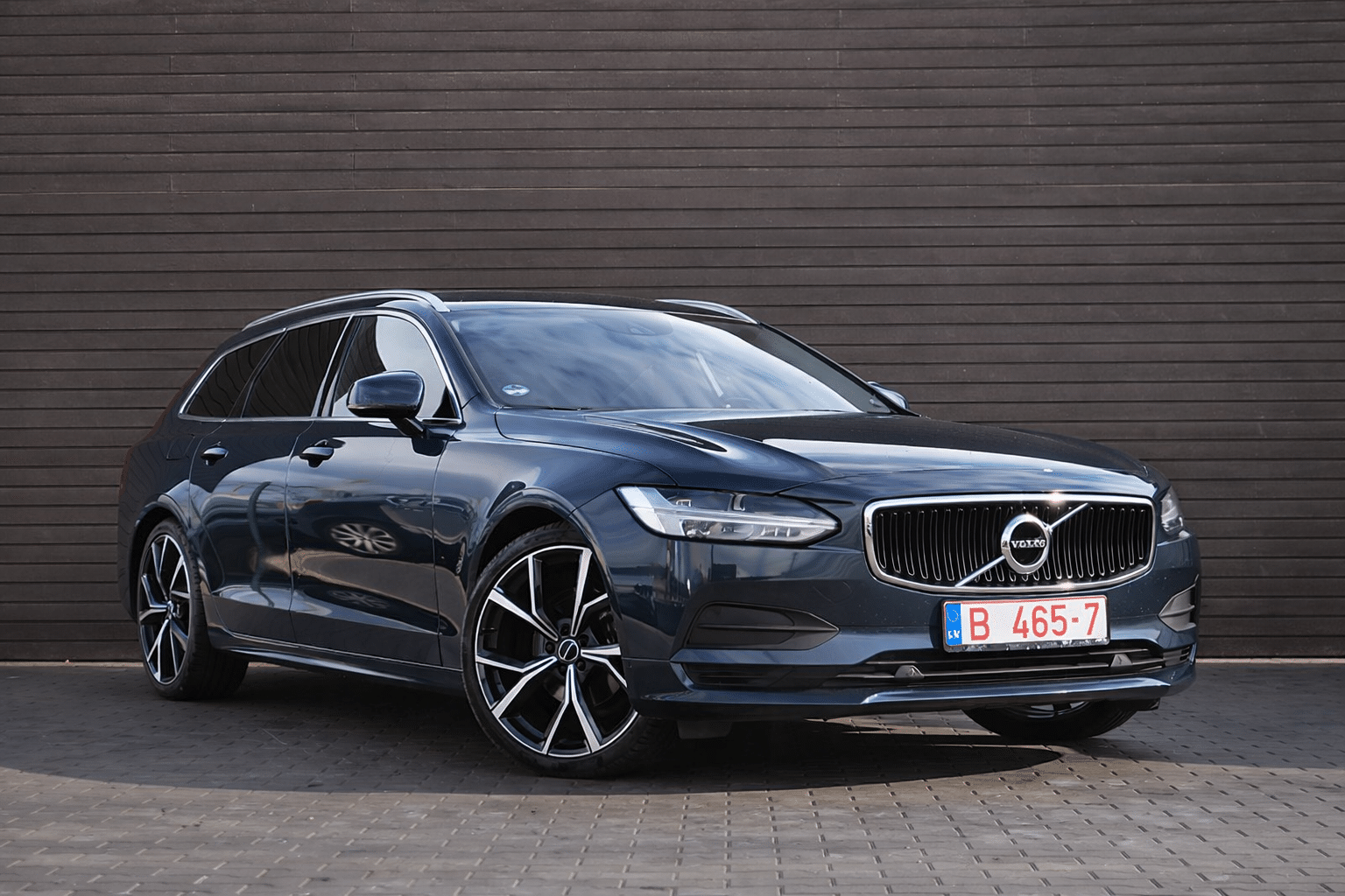 Sleek Volvo V90 by wooden wall